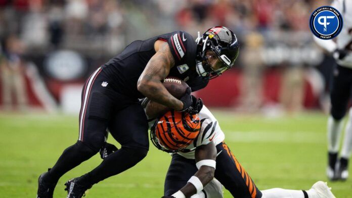 Arizona Cardinals running back James Conner (left) is tackled by Cincinnati Bengals safety Nick Scott.