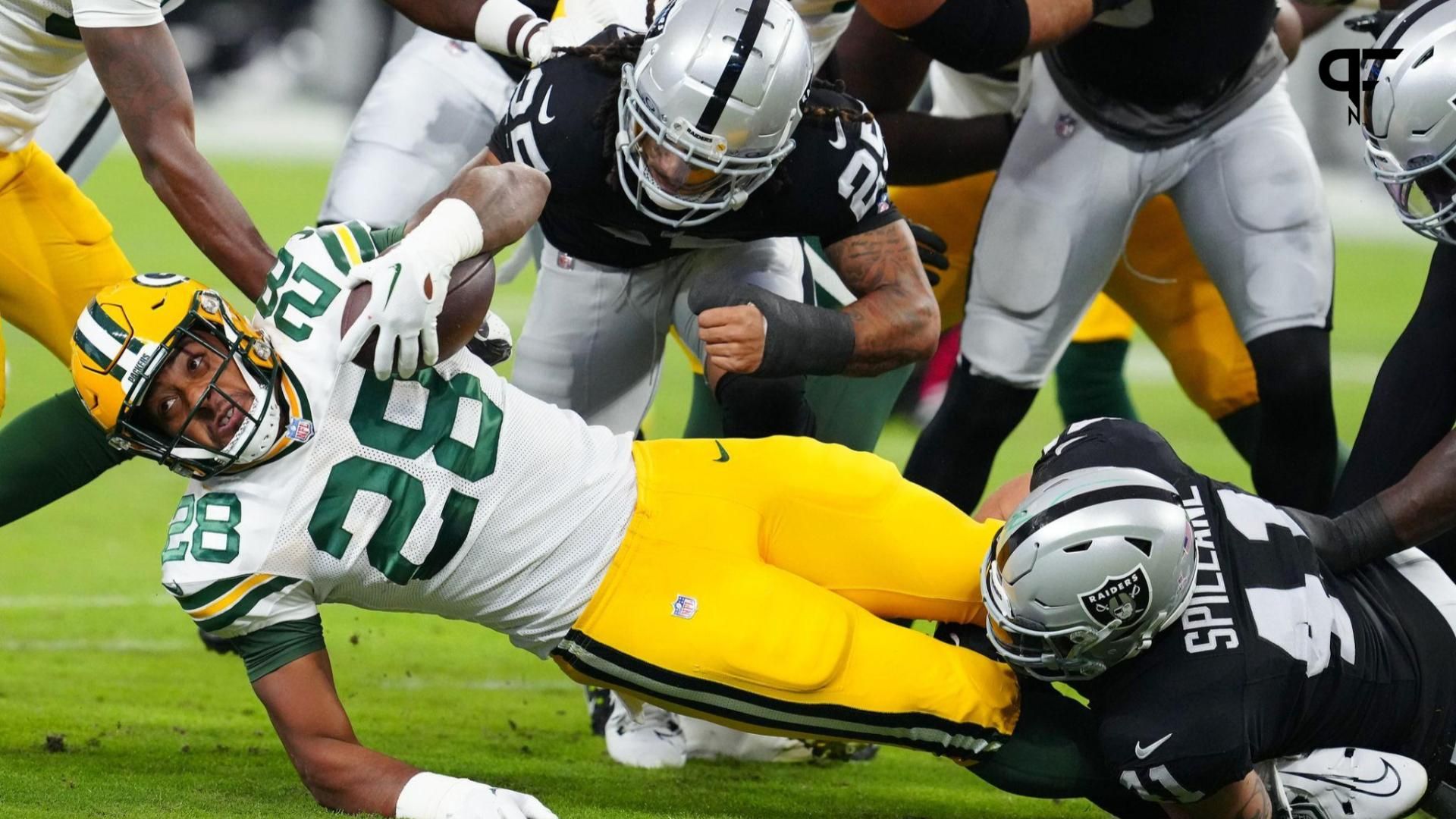 Green Bay Packers running back AJ Dillon (28) is tackled by Las Vegas Raiders linebacker Robert Spillane (41) during the first quarter at Allegiant Stadium.