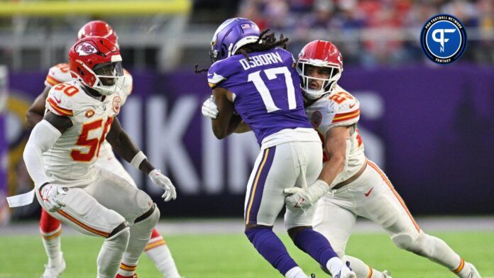 Kansas City Chiefs linebacker Drue Tranquill (23) tackles Minnesota Vikings wide receiver K.J. Osborn (17) as linebacker Willie Gay (50) watches during the third quarter at U.S. Bank Stadium.