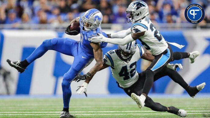 Lions wide receiver Josh Reynolds makes catch against Panthers safety Sam Franklin Jr., center, and cornerback D'Shawn Jamison during the first half on Sunday, Oct. 8, 2023, at Ford Field.