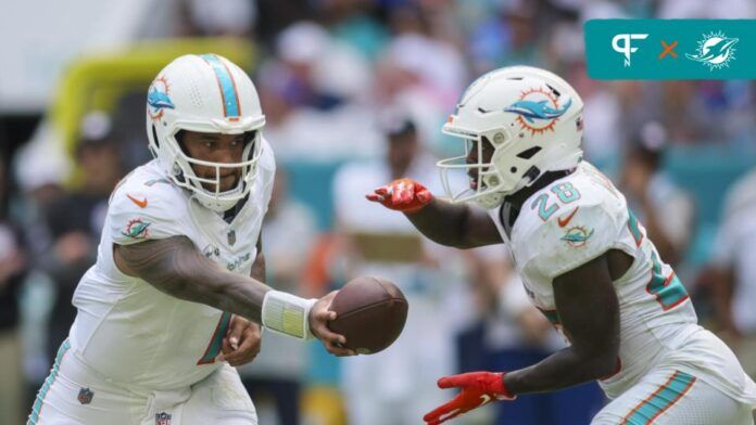 Miami Dolphins QB Tua Tagovailoa (1) hands the ball off to RB De'Von Achane (28).