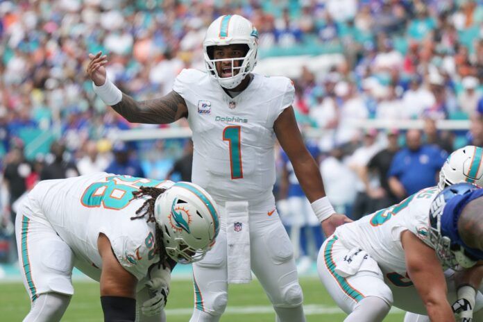 Miami Dolphins quarterback Tua Tagovailoa (1) moves players around during the first half of an NFL game against the New York Giants at Hard Rock Stadium in Miami Gardens, October 8, 2023.