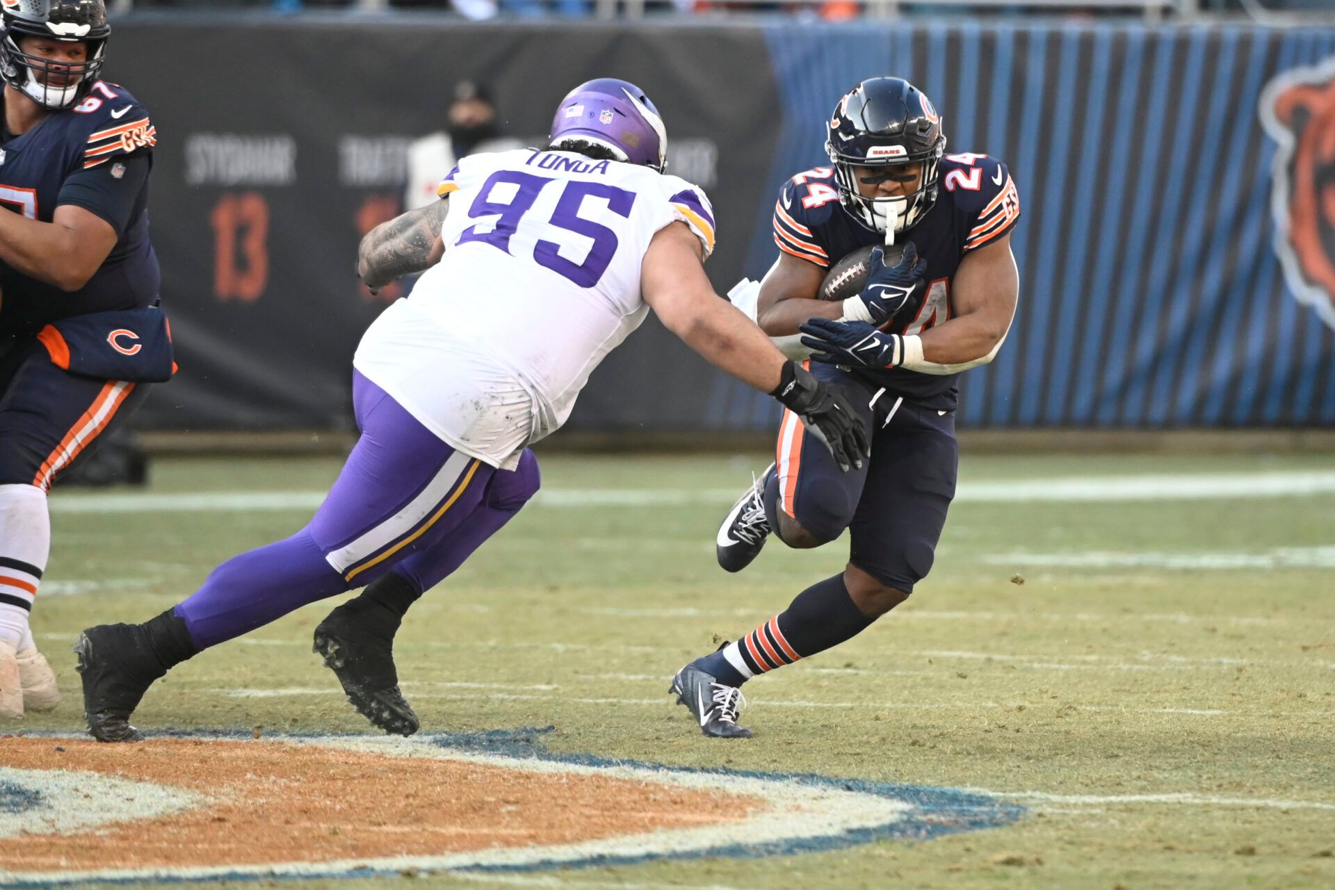 Chicago Bears running back Khalil Herbert (24) runs against the Minnesota Vikings defensive tackle Khyiris Tonga (95) during the second half at Soldier Field.