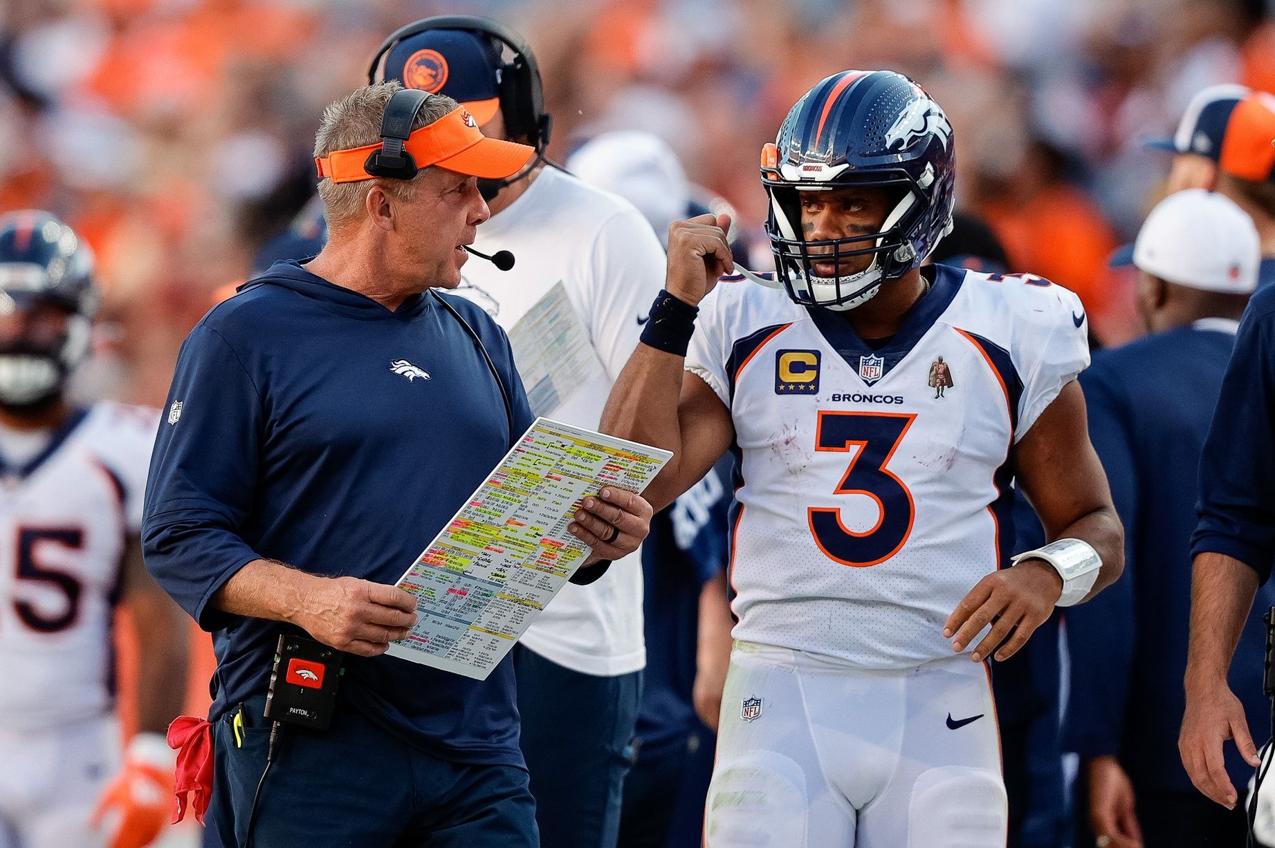 Denver Broncos head coach Sean Payton talks with quarterback Russell Wilson (3) in the fourth quarter against the Washington Commanders.