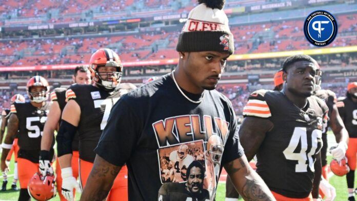 Cleveland Browns QB Deshaun Watson walks off the field in street clothes.