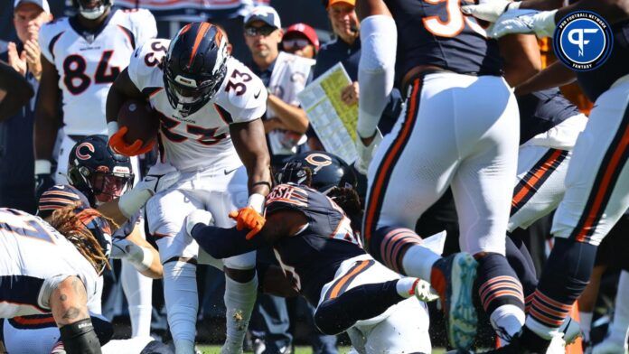 Denver Broncos running back Javonte Williams (33) rushes the ball against Chicago Bears linebacker DeMarquis Gates (43).