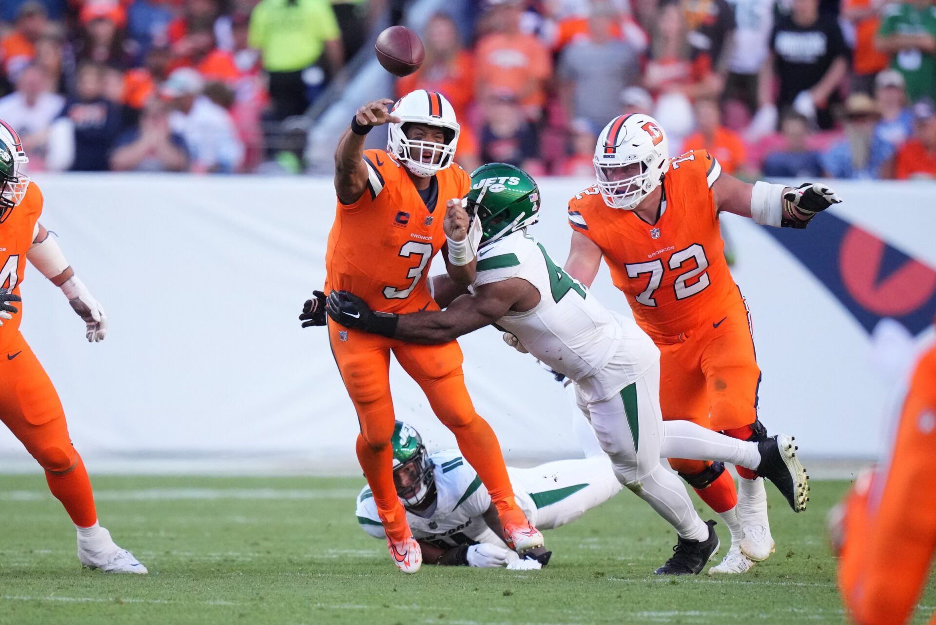 New York Jets linebacker Bryce Huff (47) tackles Denver Broncos quarterback Russell Wilson (3).