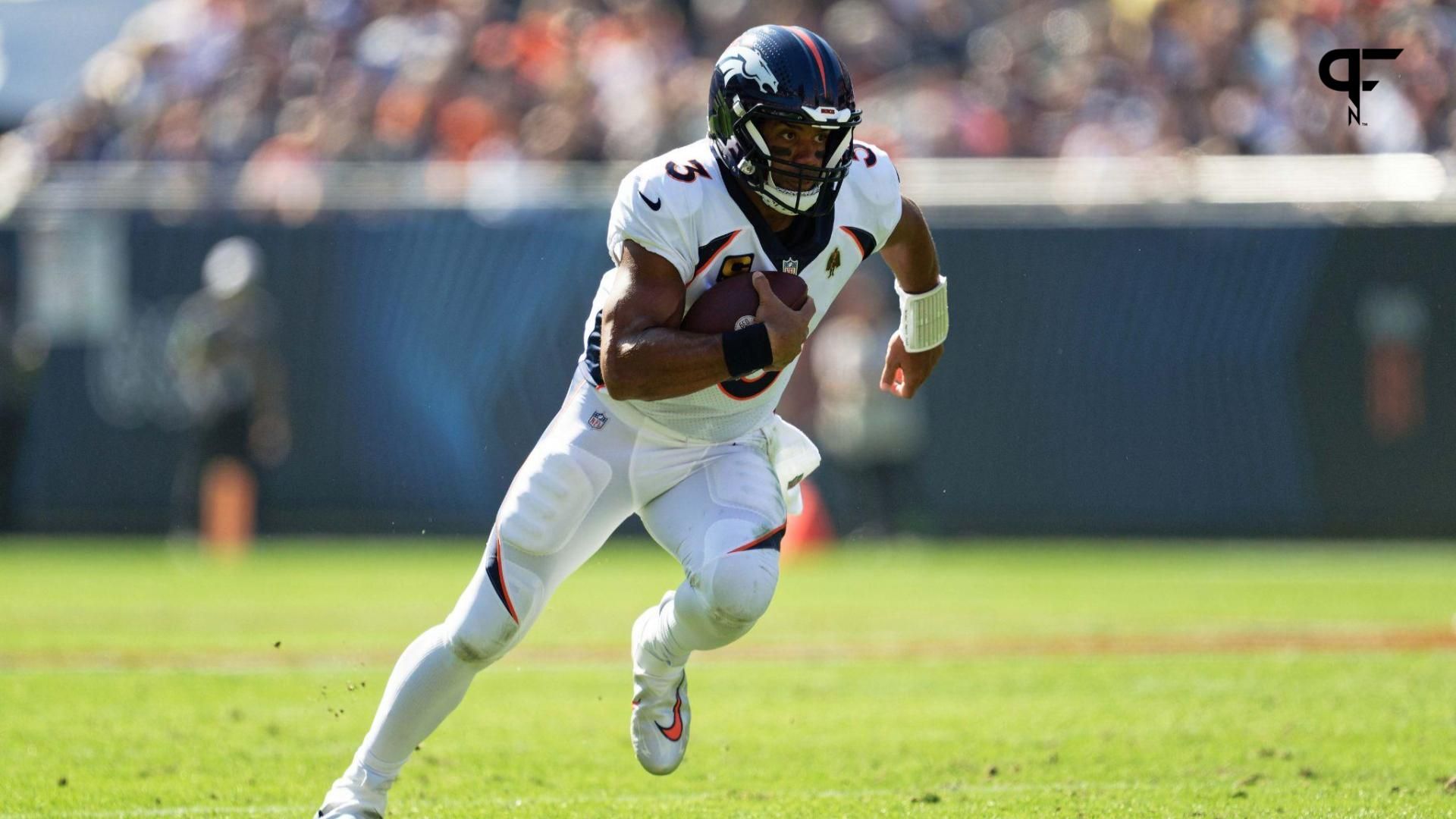 Denver Broncos quarterback Russell Wilson (3) runs with the ball against the Chicago Bears at Soldier Field.