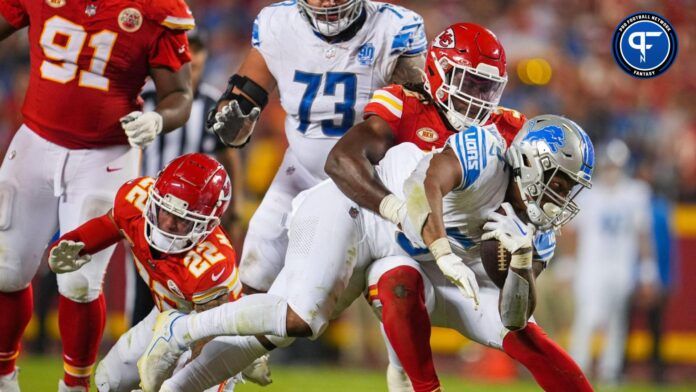 Detroit Lions running back David Montgomery (5) is tackled by Kansas City Chiefs linebacker Nick Bolton (32) and cornerback Trent McDuffie (22) during the second half at GEHA Field at Arrowhead Stadium.