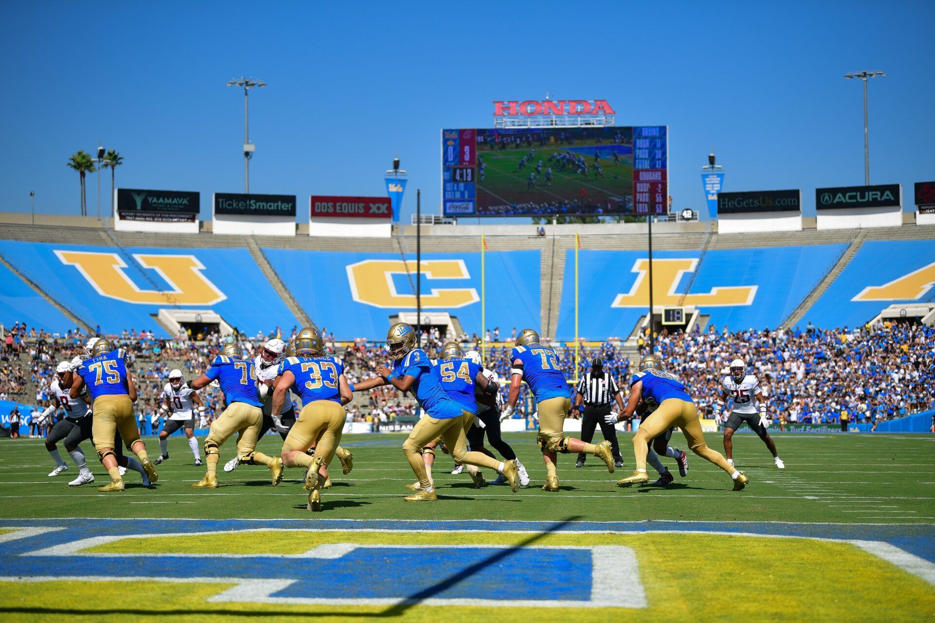 UCLA Bruins quarterback Dante Moore (3) hands the ball off to running back Carson Steele (33) during the first half at Rose Bowl.