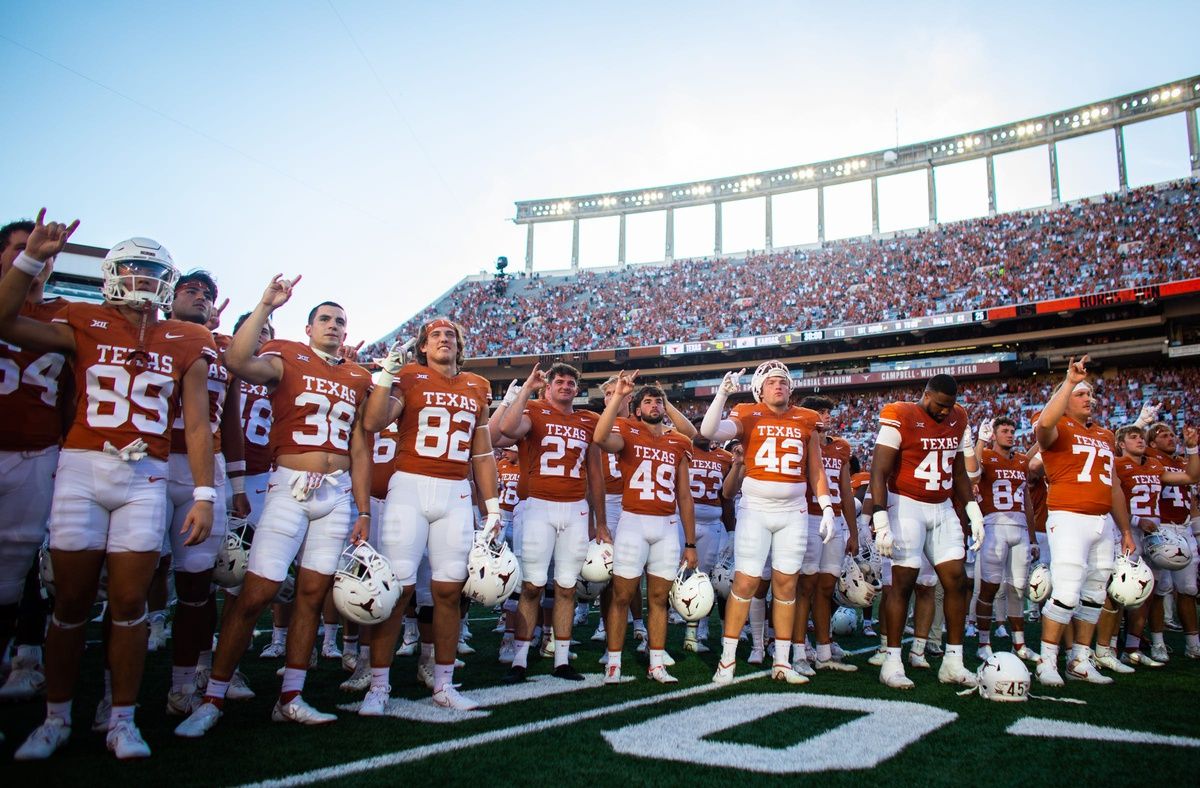 Texas gather in front of the student section to sing 