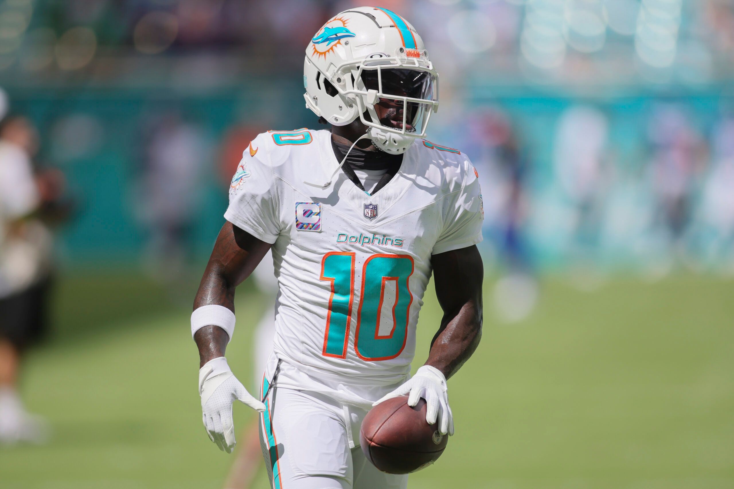 Oct 8, 2023; Miami Gardens, Florida, USA; Miami Dolphins wide receiver Tyreek Hill (10) runs with the football prior to the game against the New York Giants at Hard Rock Stadium. 