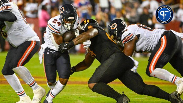 Chicago Bears running back Khalil Herbert (24) carries the ball past Washington Commanders defensive tackle Daron Payne (94) during the first half at FedExField.