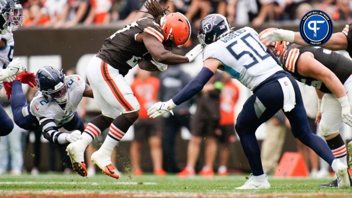 Cleveland Browns running back Kareem Hunt (27) is stopped by Tennessee Titans linebackers Azeez Al-Shaair (2) and Jack Gibbens (50) during the fourth quarter at Cleveland Browns Stadium.