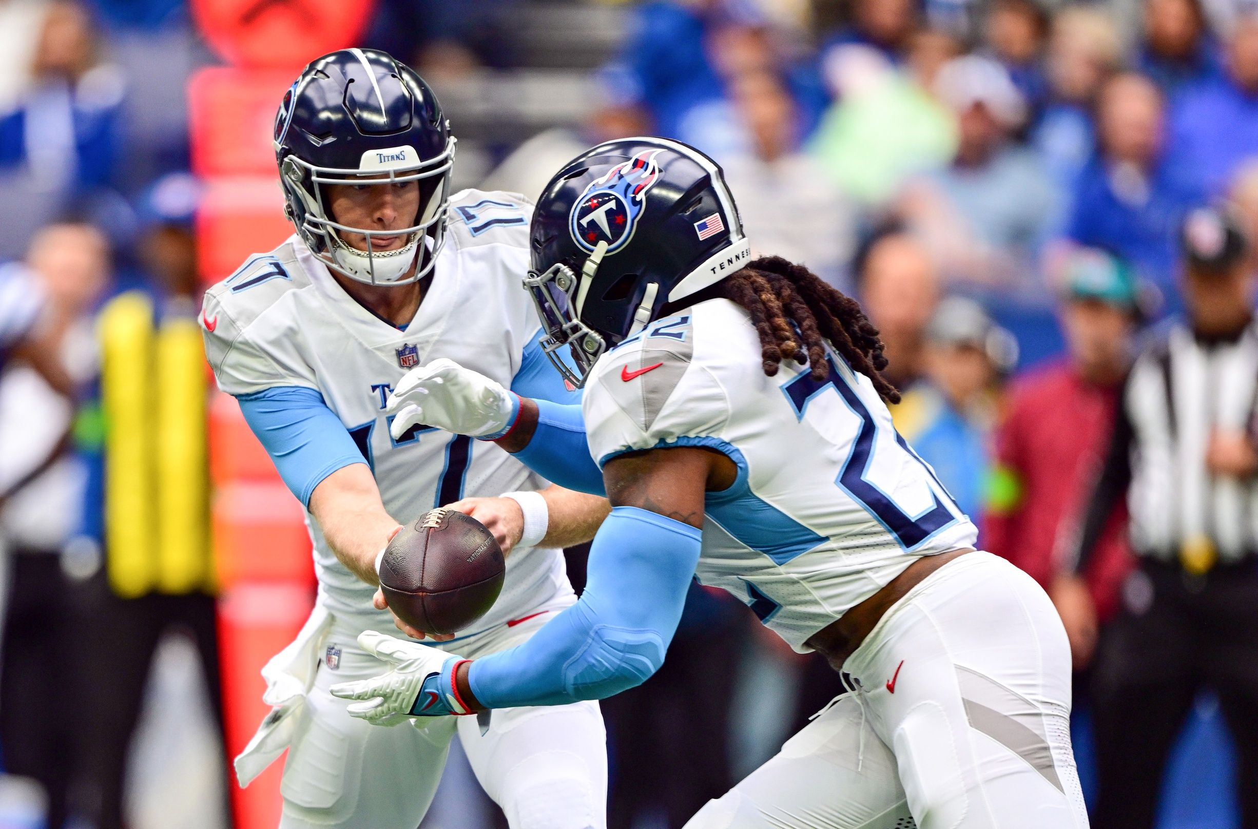Ryan Tannehill (17) hands the ball off to Tennessee Titans running back Derrick Henry (22) during the first quarter against the Indianapolis Colts at Lucas Oil Stadium.