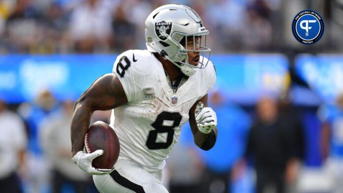 Josh Jacobs (8) runs the ball against the Los Angeles Chargers during the second half at SoFi Stadium.