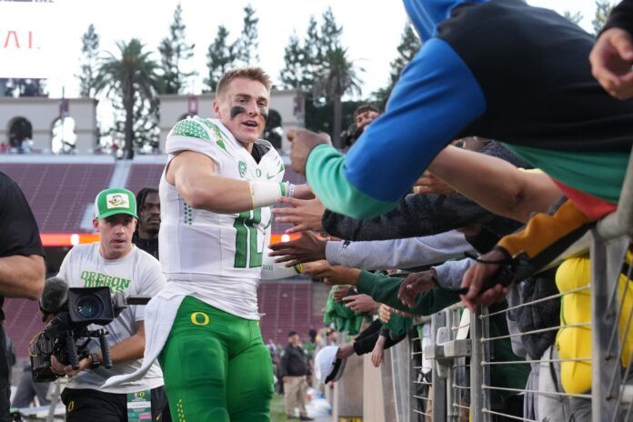 Oregon Ducks quarterback Bo Nix (10) celebrates with fans after defeating the Stanford Cardinal at Stanford Stadium.