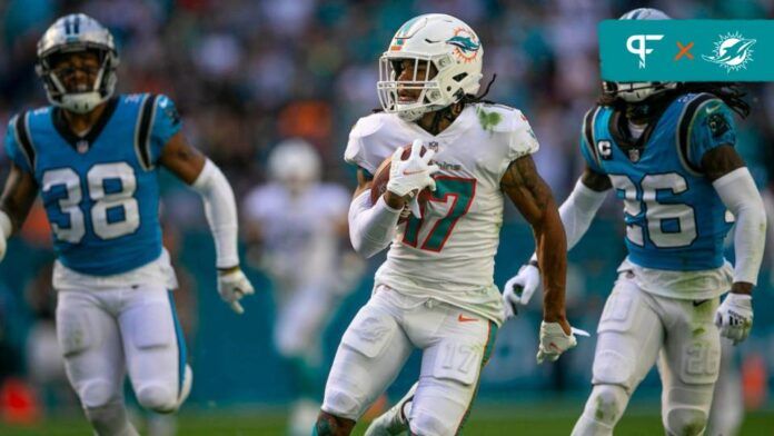 Miami Dolphins wide receiver Jaylen Waddle (17), runs by Carolina Panthers defensive back Myles Hartsfield (38) and Carolina Panthers cornerback Donte Jackson (26), for a long gain that would lead to a touchdown late in the quarter of their NFL game at Hard Rock Stadium Sunday in Miami Gardens.