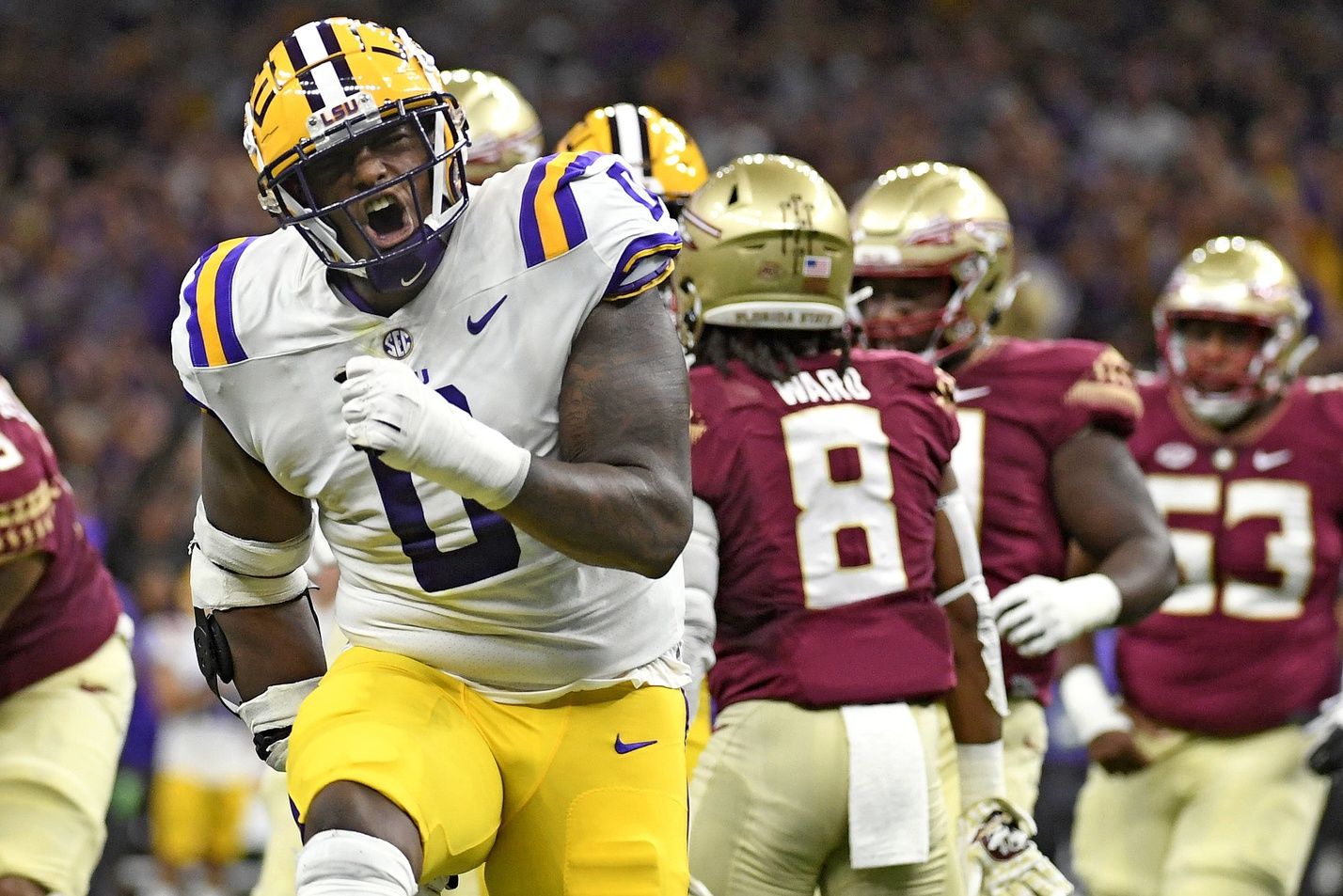 Maason Smith (0) celebrates a play during the first half against the Florida State Seminoles at Caesars Superdome.