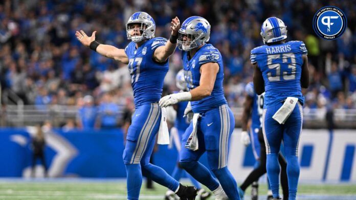 Aidan Hutchinson (97) tries to fire up the crowd after sacking Carolina Panthers quarterback Bryce Young (9) in the third quarter at Ford Field.