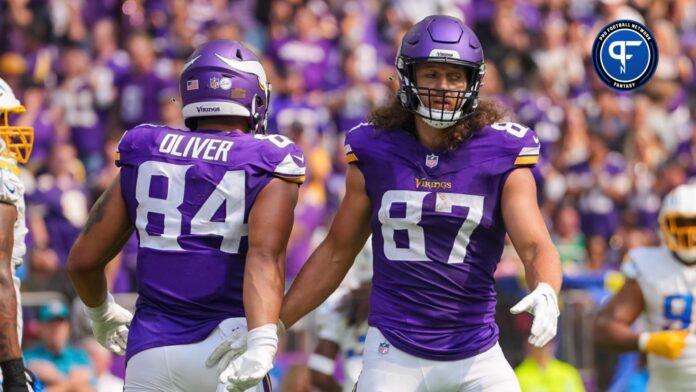 Josh Oliver (84) celebrates his touchdown with tight end T.J. Hockenson (87) against the Los Angeles Chargers in the second quarter at U.S. Bank Stadium.