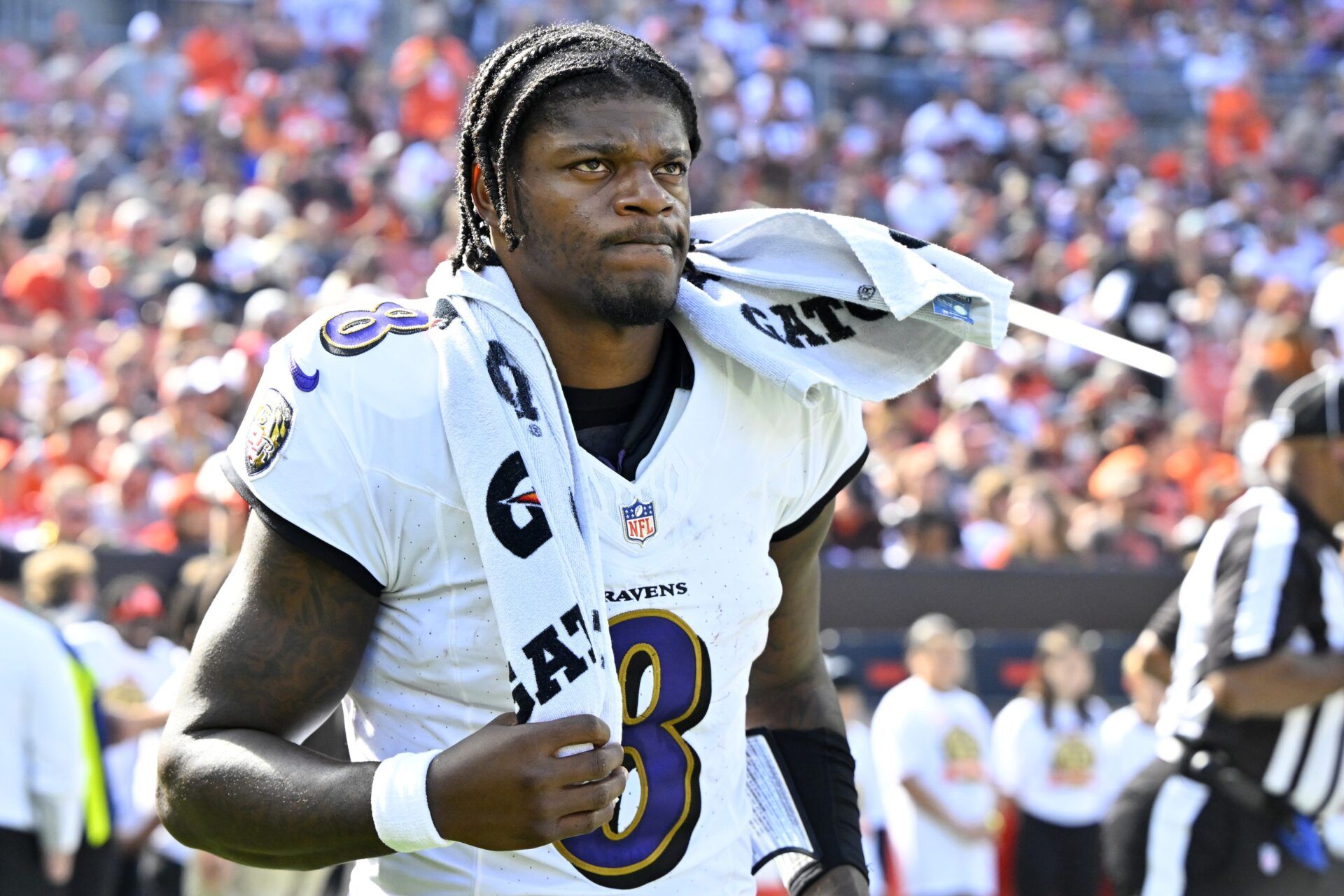 Lamar Jackson (8) walks on the field at halftime of a game against the Cleveland Browns at Cleveland Browns Stadium.