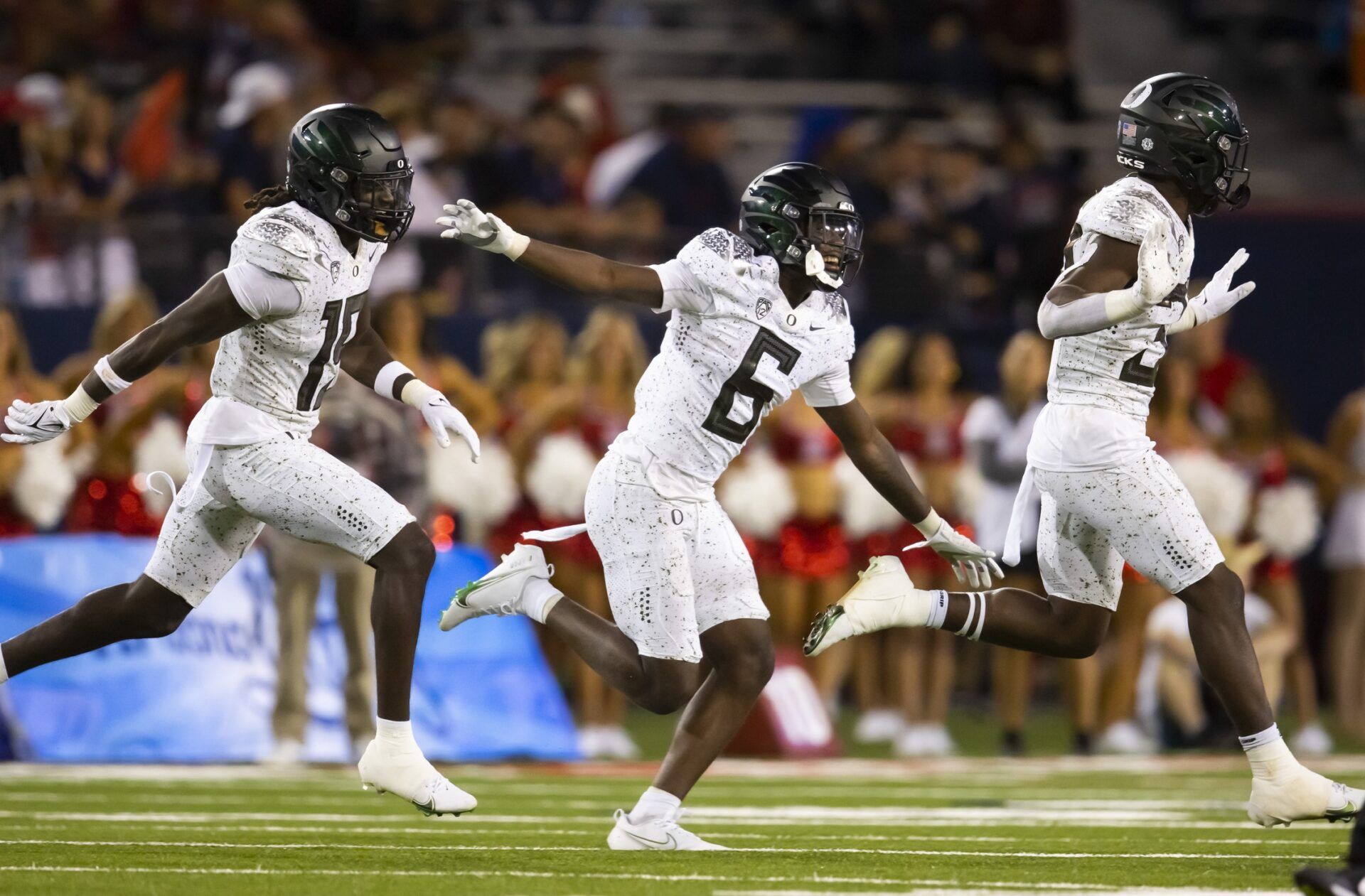 Jahlil Florence (6) celebrates an interception with Jamal Hill (19) and linebacker Jeffrey Bassa (33) against the Arizona Wildcats at Arizona Stadium.