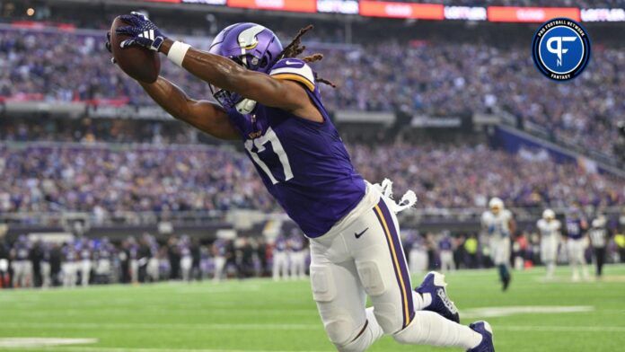 K.J. Osborn (17) scores on a touchdown pass against the Los Angeles Chargers during the third quarter at U.S. Bank Stadium.