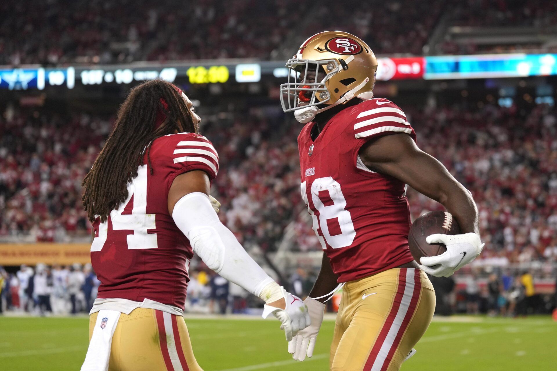 San Francisco 49ers LBs Oren Burks (48) and Fred Warner (54) celebrate after an interception.