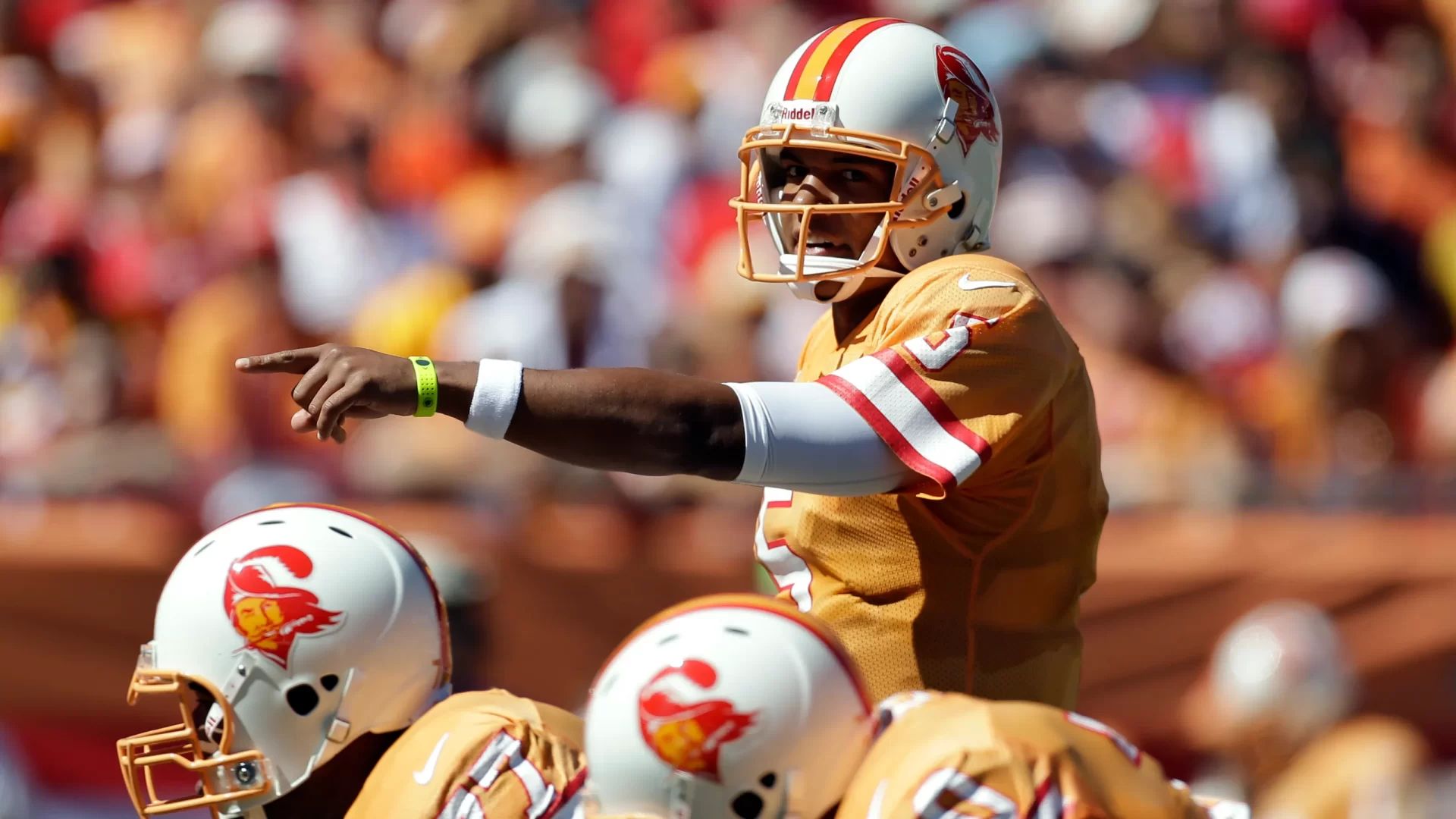 The Tampa Bay Buccaneers line up for a play in their throwback creamsicle jerseys.