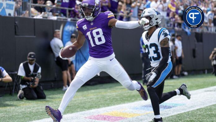 Minnesota Vikings WR Justin Jefferson (18) scores a touchdown in the back of the end zone against the Carolina Panthers.