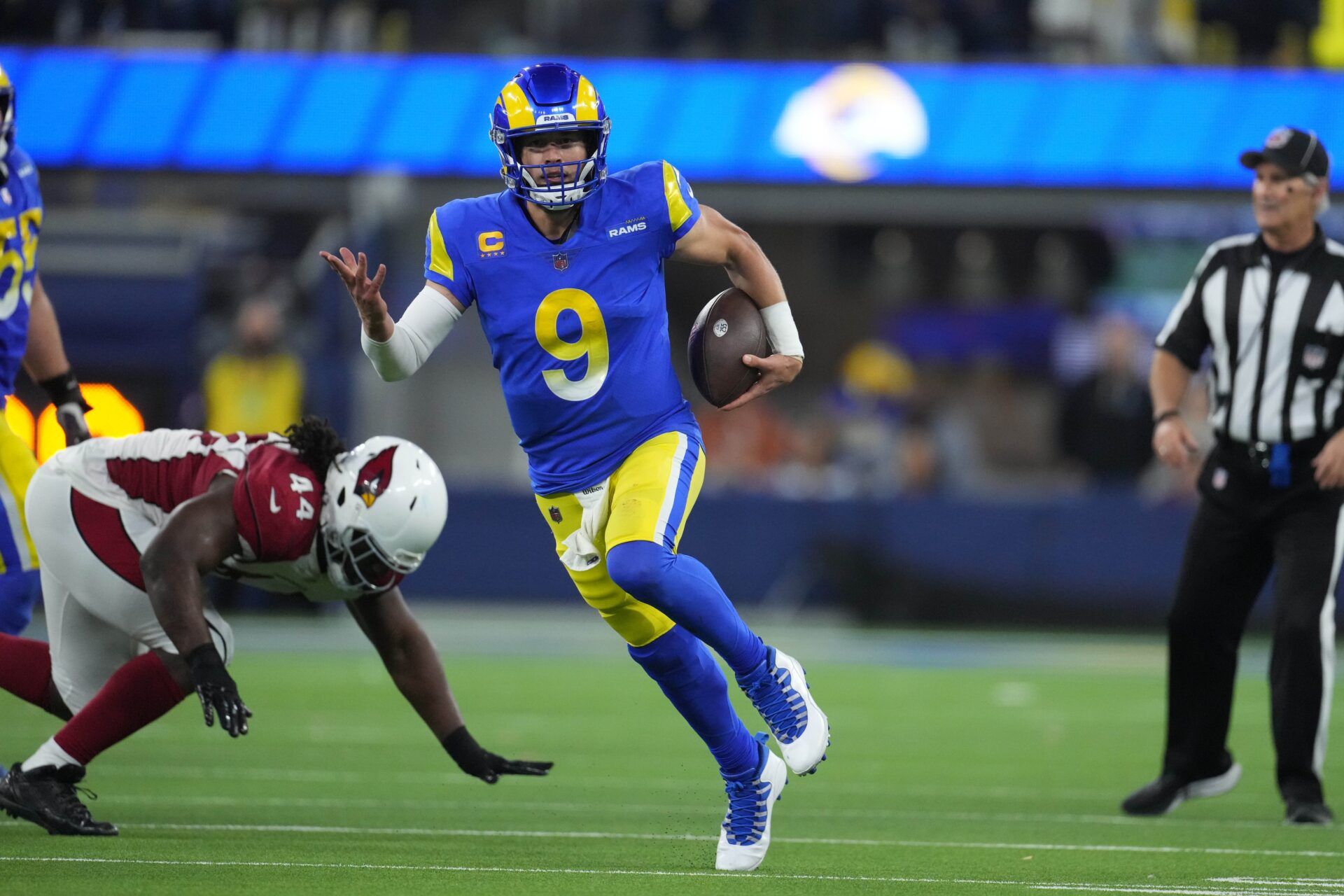 Los Angeles Rams QB Matthew Stafford (9) runs with the ball against the Arizona Cardinals.