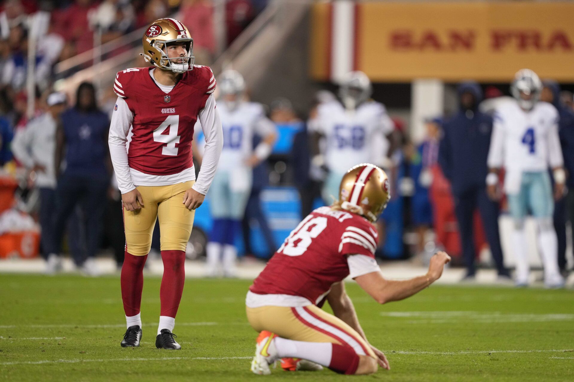 San Francisco 49ers place kicker Jake Moody (4) prepares to kick an extra point with punter Mitch Wishnowsky (18) against the Dallas Cowboys during the fourth quarter at Levi's Stadium.