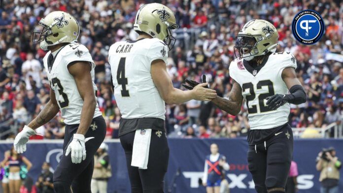 New Orleans Saints wide receiver Rashid Shaheed (22) celebrates with quarterback Derek Carr (4) after scoring a touchdown during the first quarter against the Houston Texans at NRG Stadium.