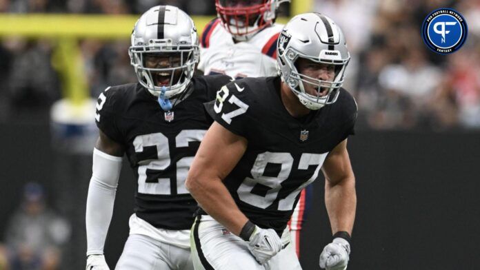 Michael Mayer (87) celebrates a first down with running back Ameer Abdullah (22) against the New England Patriots in the first quarter at Allegiant Stadium.