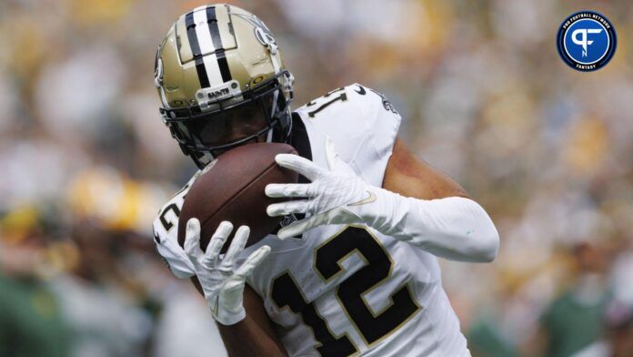 Chris Olave (12) catches a pass during the second quarter against the Green Bay Packers at Lambeau Field.