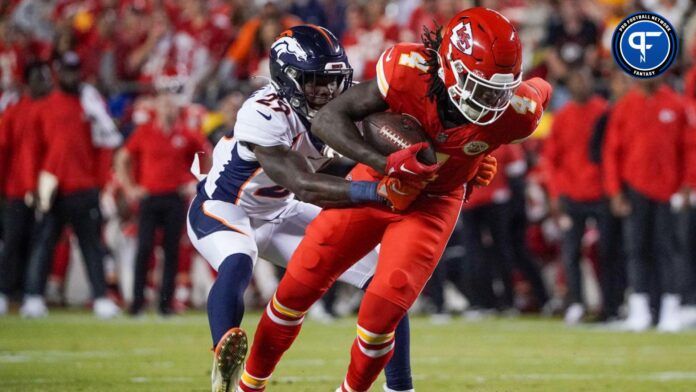 Rashee Rice (4) runs the ball as Denver Broncos cornerback Ja'Quan McMillian (29) makes the tackle during the first half at GEHA Field at Arrowhead Stadium.