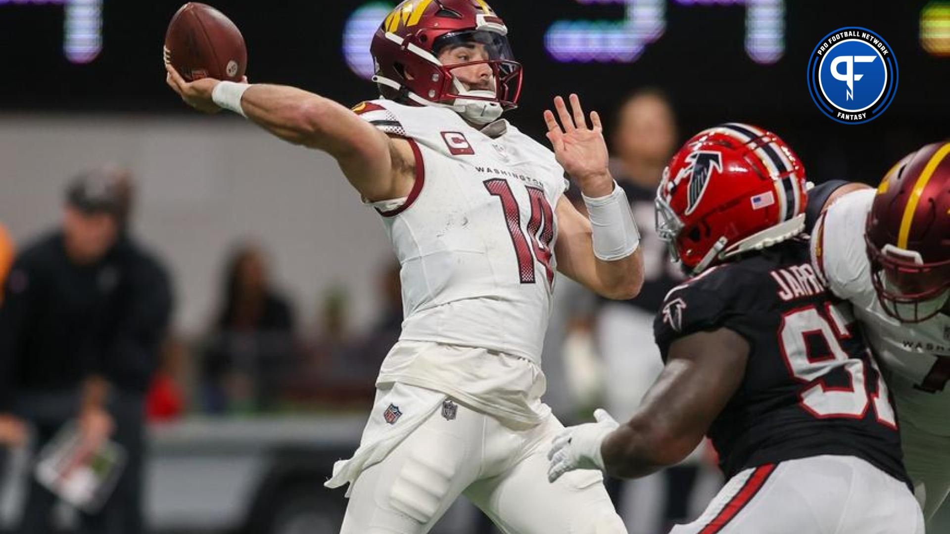 Washington Commanders quarterback Sam Howell (14) throws a pass against the Atlanta Falcons in the first quarter at Mercedes-Benz Stadium.