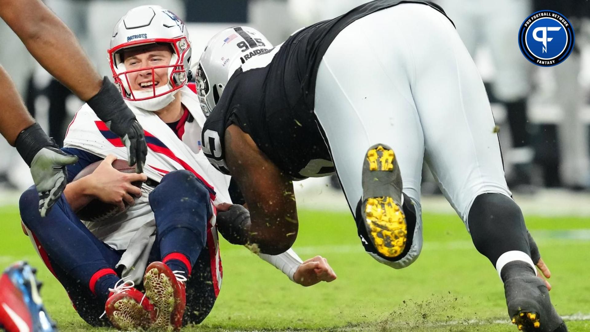 New England Patriots quarterback Mac Jones (10) is sacked by Las Vegas Raiders defensive tackle John Jenkins (95).