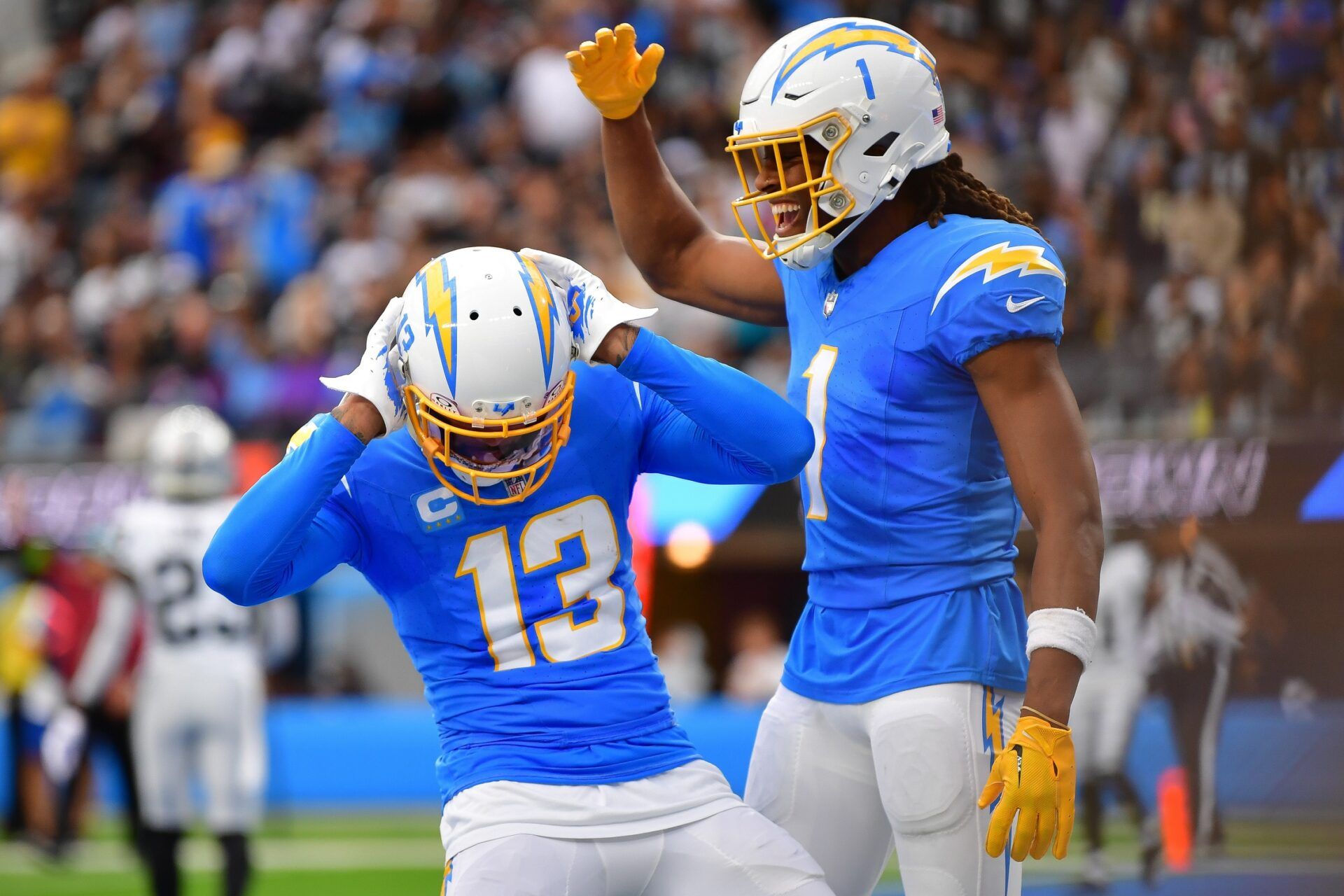 Los Angeles Chargers wide receivers Keenan Allen (13) and Quentin Johnston (1) celebrate a touchdown.