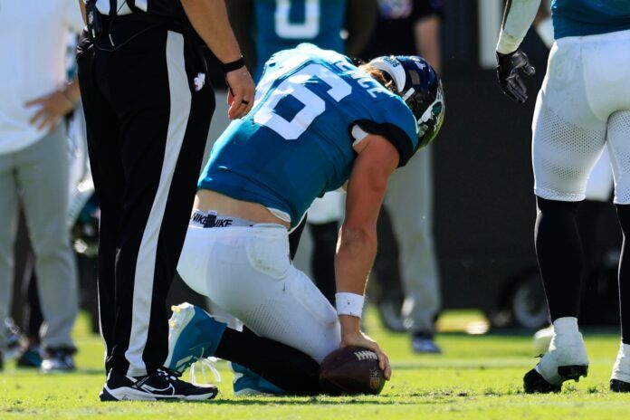 Jacksonville Jaguars quarterback Trevor Lawrence (16) is slow to get up after he landed on his knee awkwardly during the fourth quarter of an NFL football matchup Sunday, Oct. 15, 2023 at EverBank Stadium in Jacksonville, Fla.