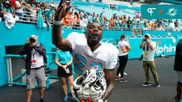 Miami Dolphins running back Jeff Wilson Jr. throws his gloves to fans after the scrimmage at Hard Rock Stadium, Saturday, August 5, 2023 in Miami Gardens.