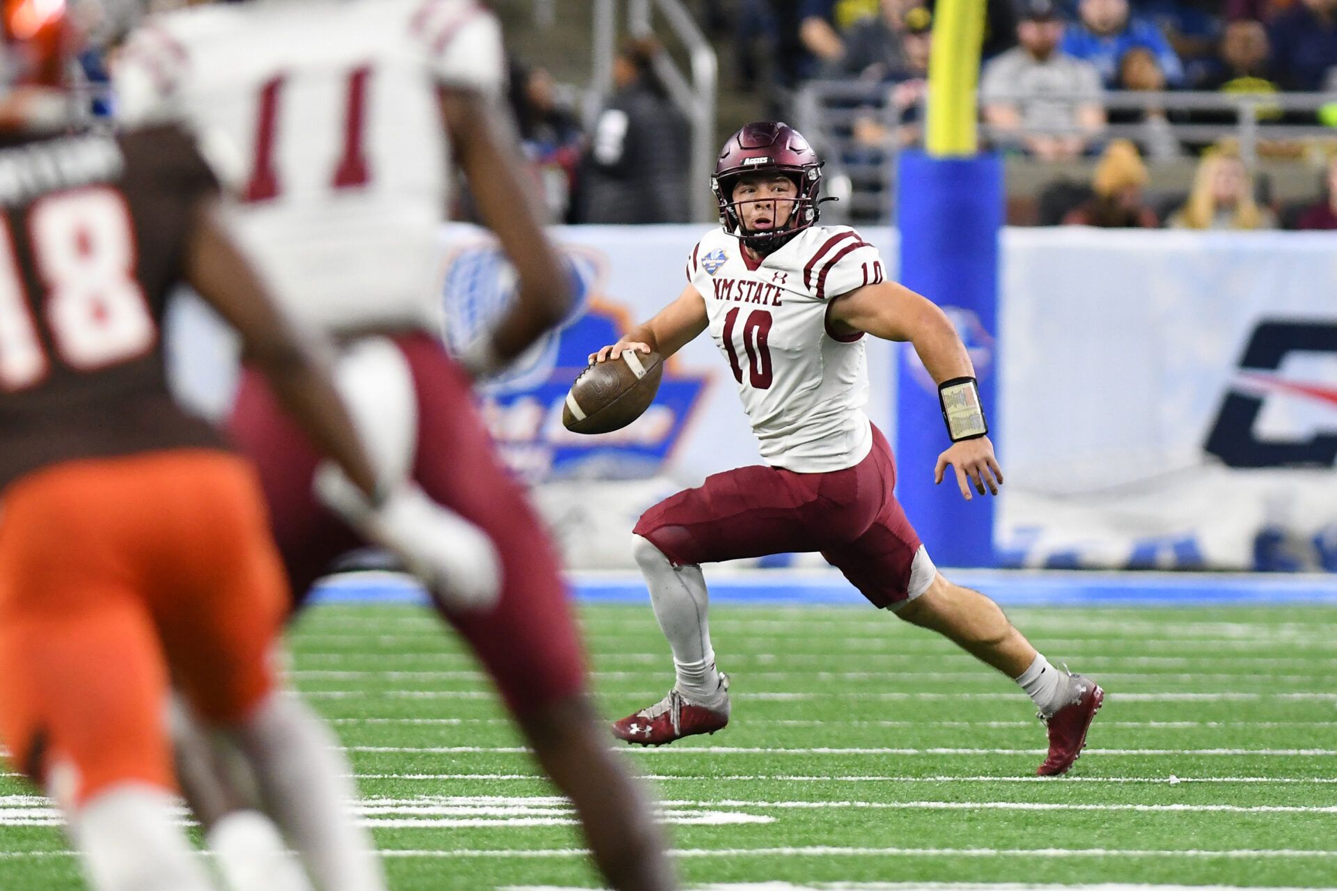 New Mexico State University quarterback Diego Pavia (10) looks for a receiver as he scrambles out of the pocket against Bowling Green State University in the third quarter of the 2022 Quick Lane Bowl at Ford Field.