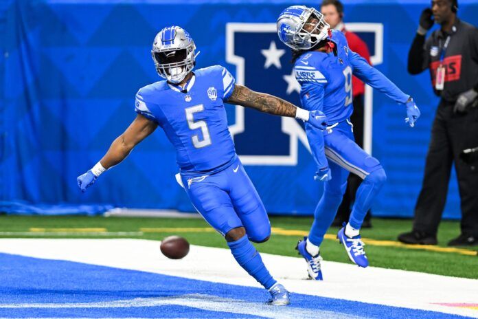 Detroit Lions running back David Montgomery (5) celebrates in the end zone with wide receiver Jameson Williams (9) after running for a touchdown against the Carolina Panthers.