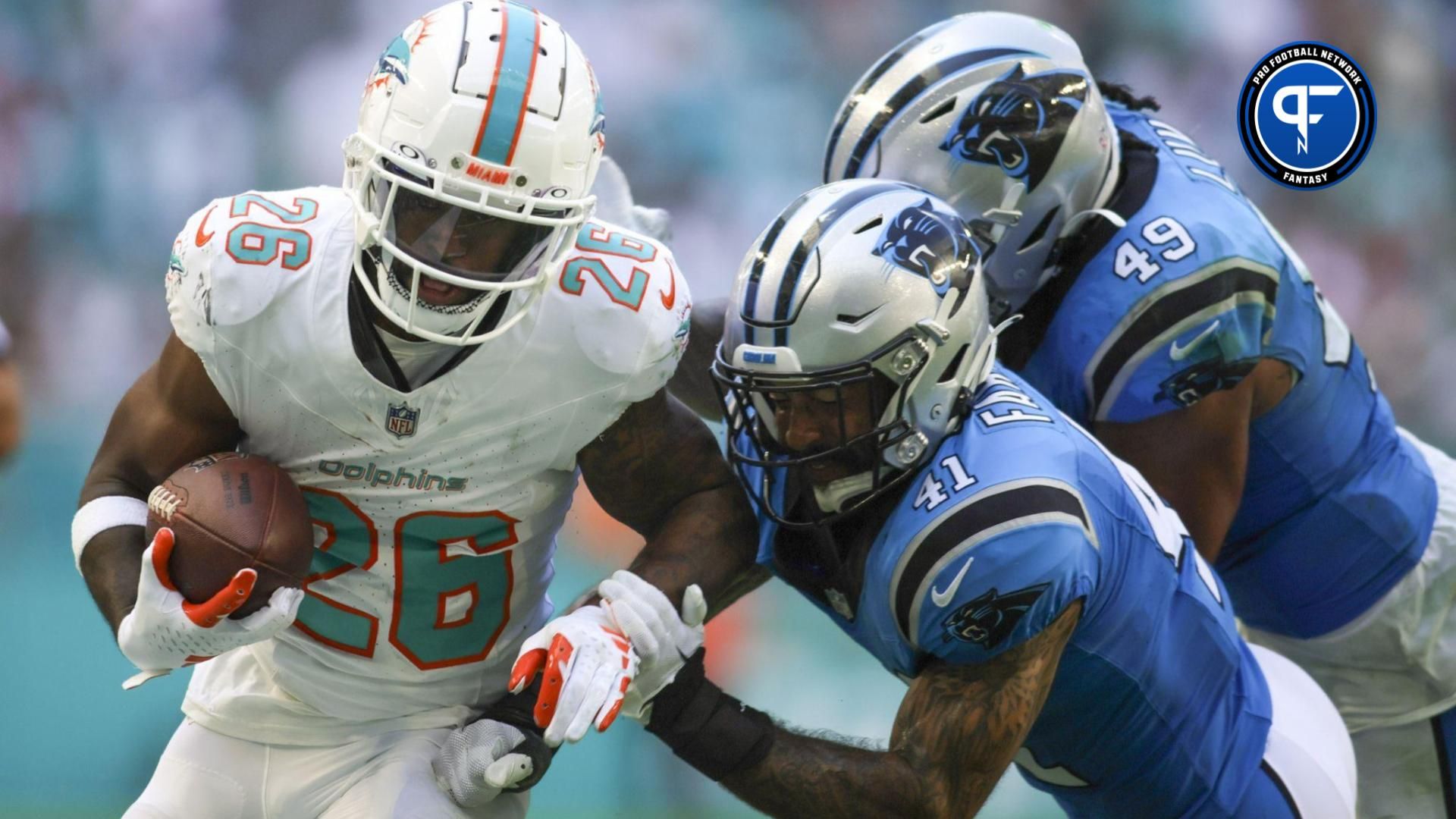 Miami Dolphins running back De'Von Achane (28) runs with the football against Carolina Panthers safety Matthias Farley (41) during the fourth quarter at Hard Rock Stadium.