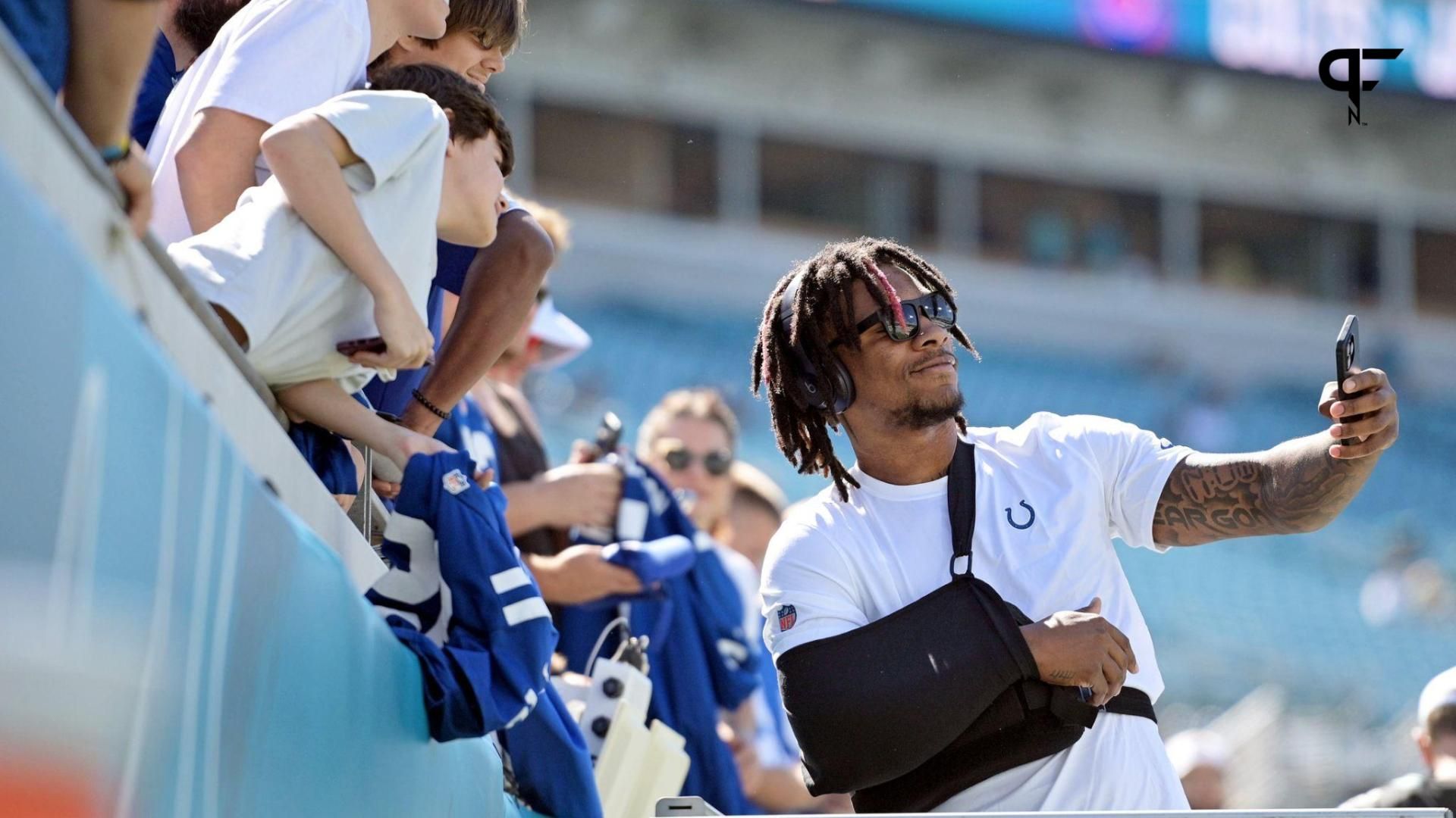 Indianapolis Colts quarterback Anthony Richardson (5) smiles and takes photos with fans before the game against the Jacksonville Jaguars at EverBank Stadium.