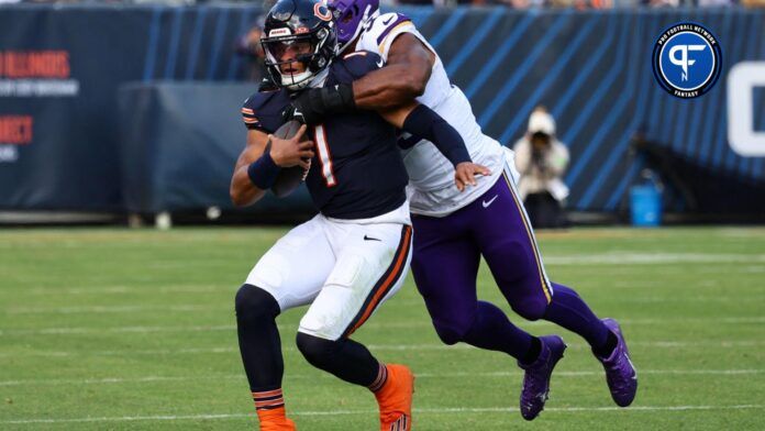 Chicago Bears QB Justin Fields (1) is tackled by Minnesota Vikings LB Danielle Hunter (99).