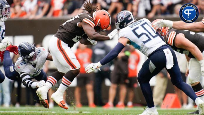 Cleveland Browns running back Kareem Hunt (27) is stopped by Tennessee Titans linebackers Azeez Al-Shaair (2) and Jack Gibbens (50).