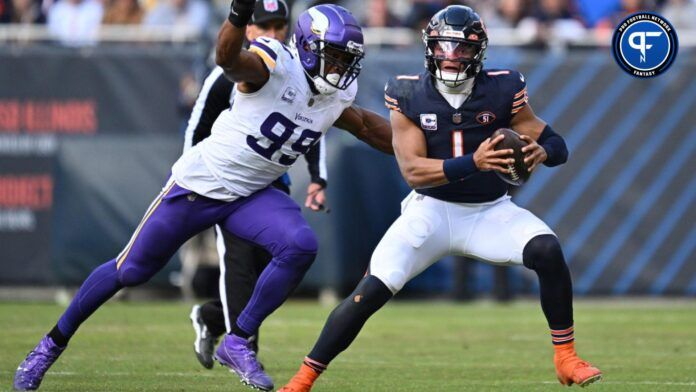 Chicago Bears quarterback Justin Fields (1) is pursued by Minnesota Vikings linebacker Danielle Hunter (99).