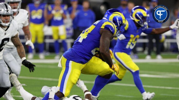 Los Angeles Rams running back Royce Freeman (24) runs over Las Vegas Raiders cornerback Sam Webb (27) during the third quarter at SoFi Stadium.